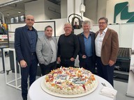 Image shows some of the Ficep UK team - Kasra Mehraky, Alireza Sabetzadeh, Richard Clark, Chris Berriman and Christian Colombo - with a celebratory cake which says 25th anniversary